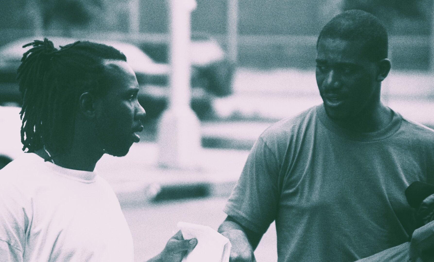 Two men engaged in a friendly conversation outdoors.