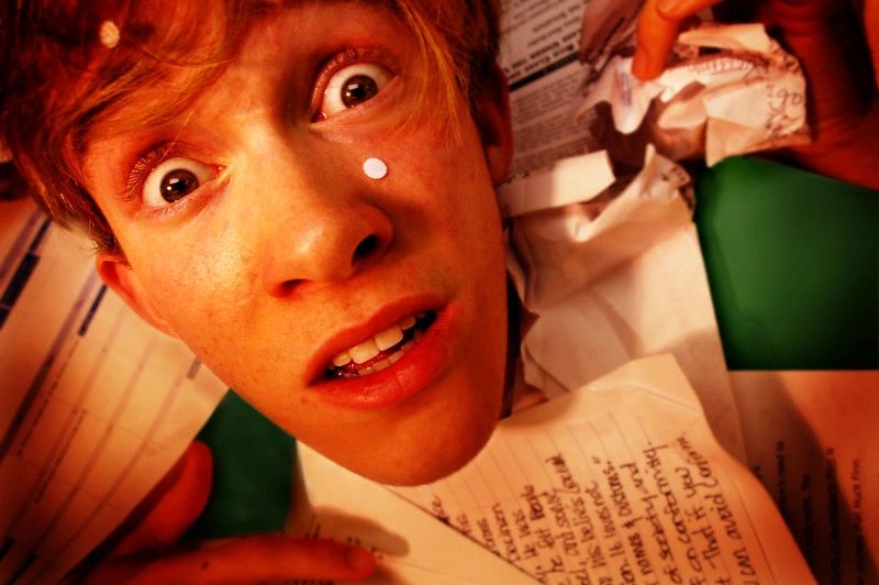 A surprised young person with wide eyes and a letter in front of them.