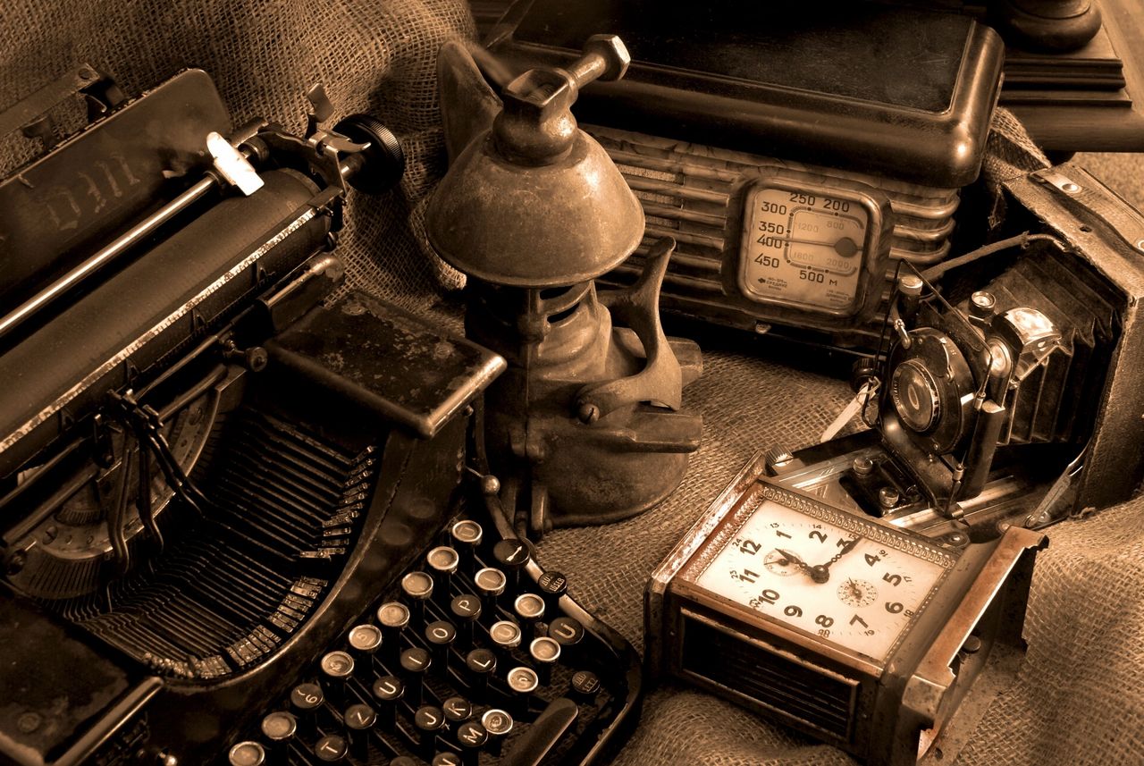 Vintage office items including a typewriter, lantern, radio, and clock.